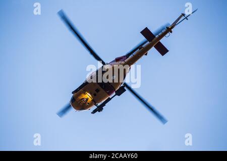 Search and rescue helicopter in the sky, view from below. Stock Photo