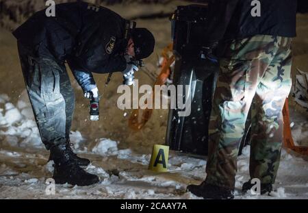 Crime scene investigation. Police officer take picture from a crime scene. Editorial use only. Stock Photo
