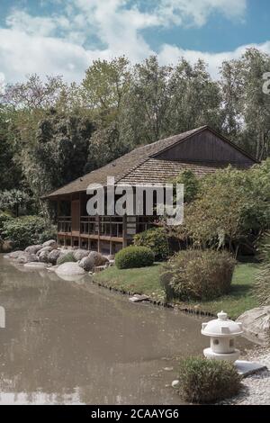 TOULOUSE, FRANCE - Apr 19, 2015: chinese garden in Toulouse , with Japanese house over lake Stock Photo