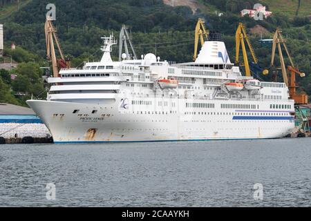 Summer view of white Japanese Passenger Cruise Liner Pacific Venus anchored at commercial sea port of Petropavlovsk-Kamchatsky City. Pacific Ocean, Ka Stock Photo