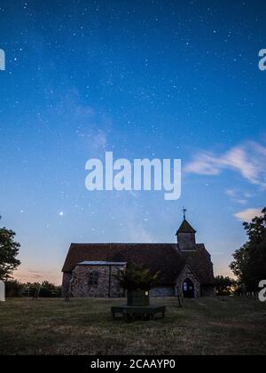 Harty, Kent, UK. 5th August, 2020. The Milky Way seen behind Harty Church in Kent (Church of St Thomas the Apostle), an early 11th or 12th century grade II listed building. Saturn and Jupiter can also be clearly seen to lower left of photos. Credit: James Bell/Alamy Live News Stock Photo