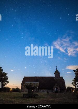 Harty, Kent, UK. 5th August, 2020. The Milky Way seen behind Harty Church in Kent (Church of St Thomas the Apostle), an early 11th or 12th century grade II listed building. Saturn and Jupiter can also be clearly seen to lower left of photos. Credit: James Bell/Alamy Live News Stock Photo