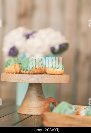 Pastel Green Cream Puffs Decorated with White Hydrangeas. Stock Photo