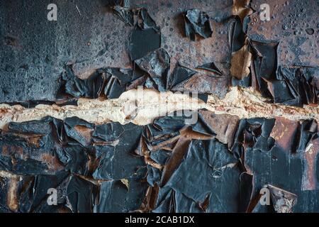 Burnt wall texture background. Burned house after fire wall surface with coal. Stock Photo