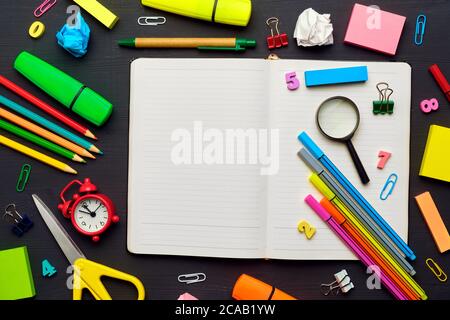 Back to school concept with different office supplies with diary on wooden board. Stock Photo
