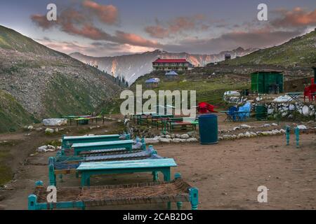 Closeup shot of tourists sitting area behind Naran kaghan saif ul malook lake in Pakistan Stock Photo