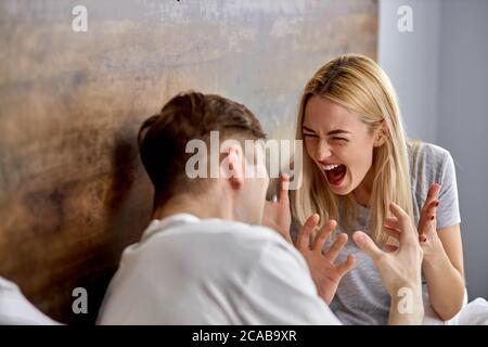 relationship of married couple is undergoing a crisis, they are quarreling, sort things out and scream. they are dissatisfied with each other Stock Photo