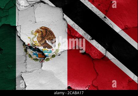 flags of Mexico and Trinidad and Tobago painted on cracked wall Stock Photo