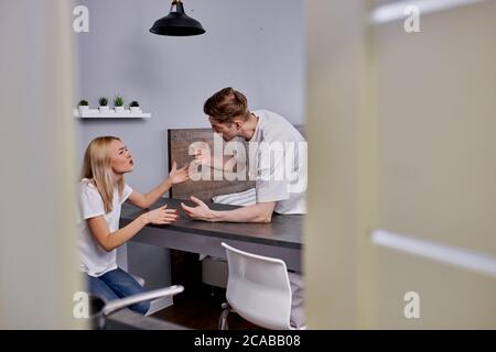 young caucasian married couple have quarrel at home, scream, argue, have family problems. couple going to get divorce Stock Photo