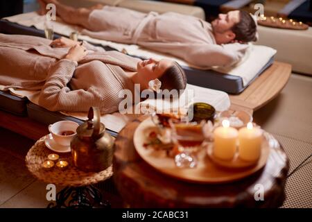 young man and woman, couple in love relaxing together at spa salon, after enjoying treatment, health and body care, holiday weekend Stock Photo