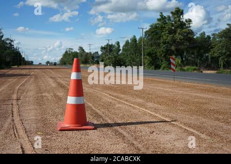 Red rubber cone is placed on the road during the construction of the road. Stock Photo