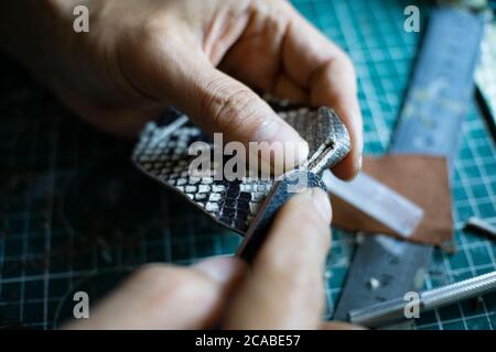 leather craftsman working Stock Photo