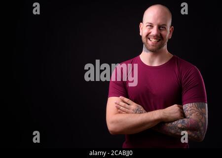 Handsome Bald Man With Beard And Tattoo Wearing Casual Polo And Glasses 