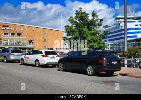 Line up of Helsinki taxi cabs waiting for passengers from Tallink Silja car ferry in Olympia Terminal, Port of Helsinki, Finland. July 6, 2020. Stock Photo