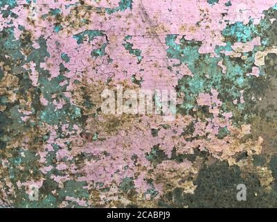 Rusty metal plate all over the background, with old layers of pie, texture. Stock Photo