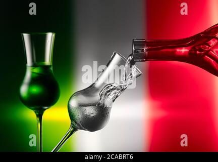 Steamed glass with tequila on a background of the Mexican flag. Pouring tequila in a glass with natural ice. Stock Photo