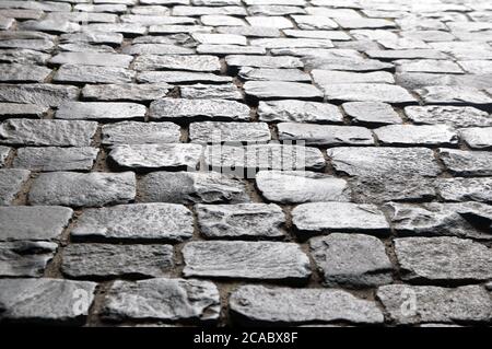 An ancient pavement lined with stone paving stones. Stock Photo