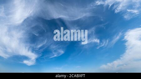 White cirrus fuzzy clouds in blue azure sky. Summer good weather panorama background. Stock Photo