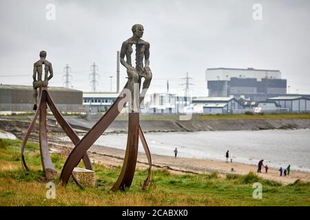 Heysham sculpture of SHIP and two figures at Half Moon Bay by artist Anna Gillespie near the port and EDF nuclear power station Stock Photo