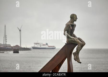 Heysham sculpture of SHIP and two figures at Half Moon Bay by artist Anna Gillespie near the port as the  ISLE OF MAN STEAM PACKET COMPANY ferry arriv Stock Photo