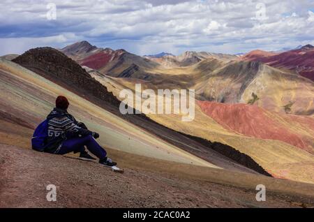 CUSCO, PERU - Jul 08, 2020: Cusco/Peru: boy admires the beautiful view on the Palccoyo rainbow mountains. Colorful landscape in the andes Stock Photo