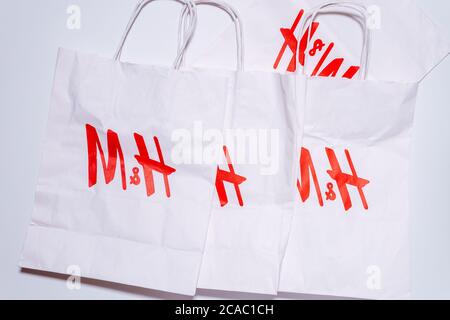 Tyumen, Russia-August 01, 2020: H and M logo on a white package top view. H and M Hennes Mauritz AB is a Swedish multinational retail-clothing company Stock Photo