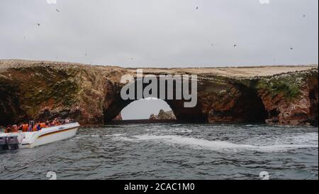 PARACAS, PERU - Sep 27, 2019: touristic boat visiting the Ballestas Islands, in Paracas. Archipelago in the Pacific, home to many animals Stock Photo