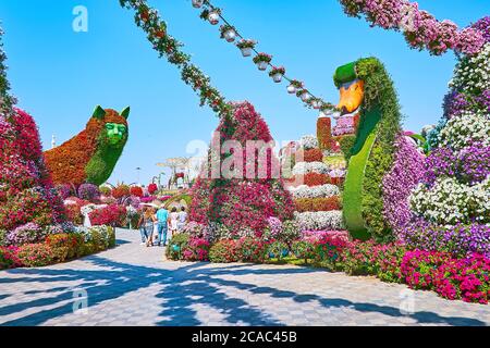 DUBAI, UAE - MARCH 5, 2020: Explore the scenic installtions of cats and swans, surrounded by flower beds and petunias in pots, Miracle Garden, on Marc Stock Photo