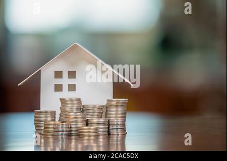 Model houses and stacked coins. Home equity loans. Mortgages and loans.