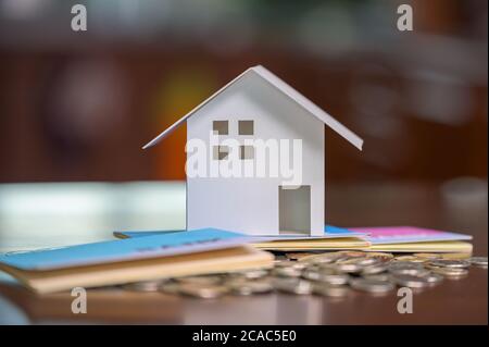 Model houses and stacked coins. Home equity loans. Mortgages and loans. Stock Photo