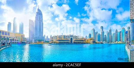 DUBAI, UAE - MARCH 3, 2020: The large man made Burj Khalifa Lake with surrounding modern high rises and low-rise Al Bahar Souq, on March 3 in Dubai Stock Photo