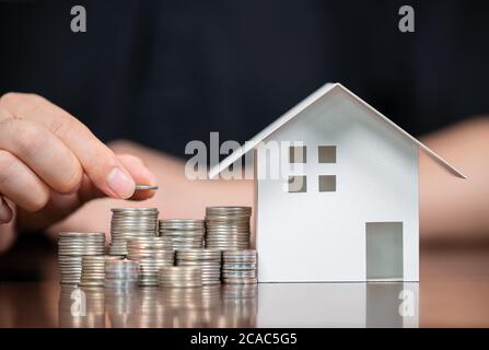Model houses and stacked coins. Home equity loans. Mortgages and loans.