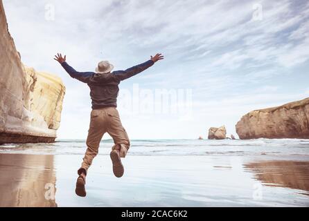 Jumping man on sunset beach Stock Photo