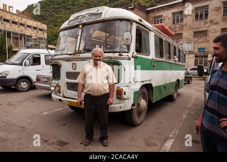 Alaverdi / Armenia - July 20, 2019: Men talking in front of public bus in Alaverdi Stock Photo