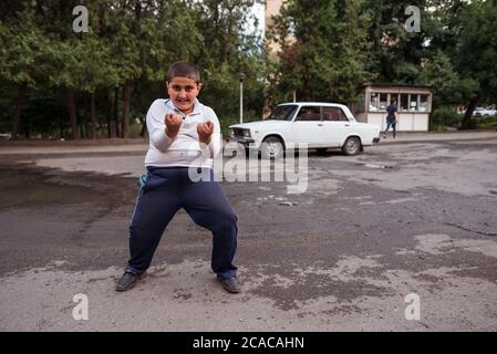 Alaverdi / Armenia - July 20, 2019: happy Armenian boy on the village street Stock Photo