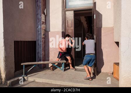 Sukhumi / Abkhazia - August 2, 2019: children playing robbing door of a house with water pistols Stock Photo