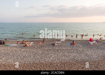 Sukhumi / Abkhazia - August 2, 2019: beach full of russian tourists during sunset Stock Photo