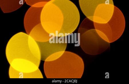 Abstract Blurred Vibrant Yellow and Orange Color Illuminated Light on Dark Background Stock Photo