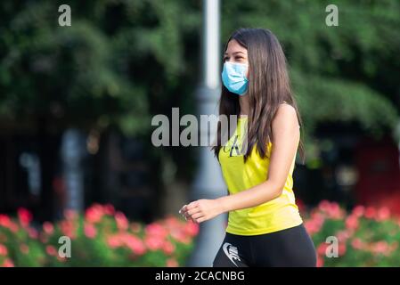 Belgrade, Serbia. 6th August, 2020. A young girl with mask walks through the city during the new Coronavirus disease (COVID-19) after the decrease of coronavirus infected in Serbia. The number of coronavirus infections is decreasing throughout Serbia. The government mandates the mandatory use of masks indoors and outdoors to halt the spread of the coronavirus disease (COVID-19). Credit: Nikola Krstic/Alamy Live News Stock Photo