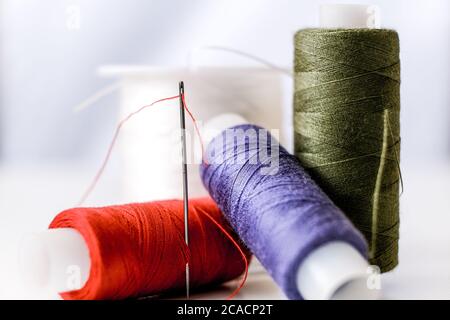 Spools of thread. Needle with thread in the eye of the needle. Stock Photo