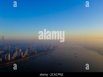 A misty sunrise in Pyongyang Yang, North Korea as viewed from the Yanggakdo hotel Stock Photo