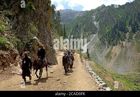 Hindu devotees visit during their pilgrimage from Baltal Base Camp to the holy place Amarnath Cave Shine located at an altitude of 12,729 feet. Stock Photo