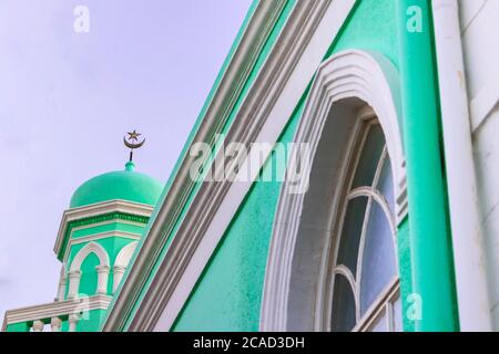 Brightly coloured green mosque in the historic neighborhood of Bo-Kaap, Cape Town, South Africa Stock Photo