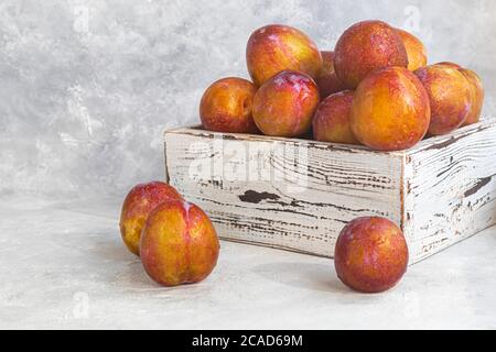 Fresh plums are yellow-red. Juicy and large. Purchase of goods for future use. Vitamins for immunity. On a light background. Copy space Stock Photo