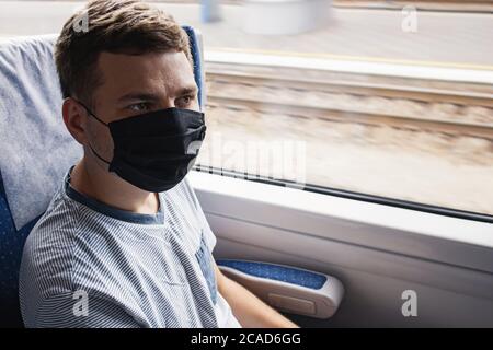 Young man wearing protective face mask sitting in the traing Stock Photo
