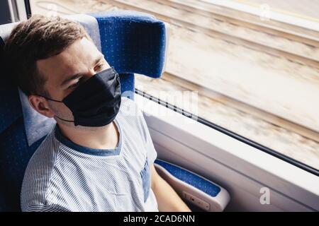 Young man wearing protective face mask sitting in the traing Stock Photo