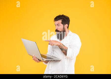 Bearded man with notebook. Online shopping. Man using notebook. Digital world. Programming concept. Programmer with laptop. Surfing internet. In search of inspiration. Online payment. Online purchase. Stock Photo