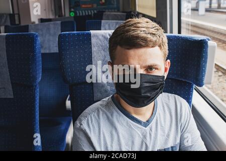 Young man wearing protective face mask sitting in the traing Stock Photo