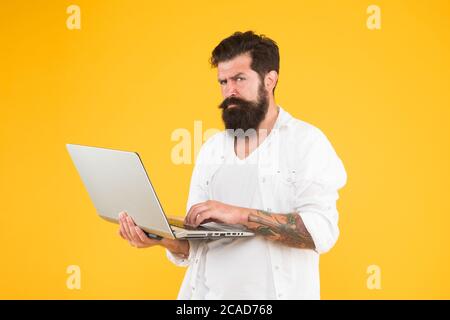 Online purchase. Man using notebook. Programming concept. Bearded man with notebook.Digital world. Successful developer. Online shopping. Programmer with laptop. Surfing internet. Online payment. Stock Photo