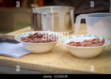 Two trendy bowl of chocolate milk and dark chips on marble table. Cooking homemade or culinary workshop concept. Stock Photo